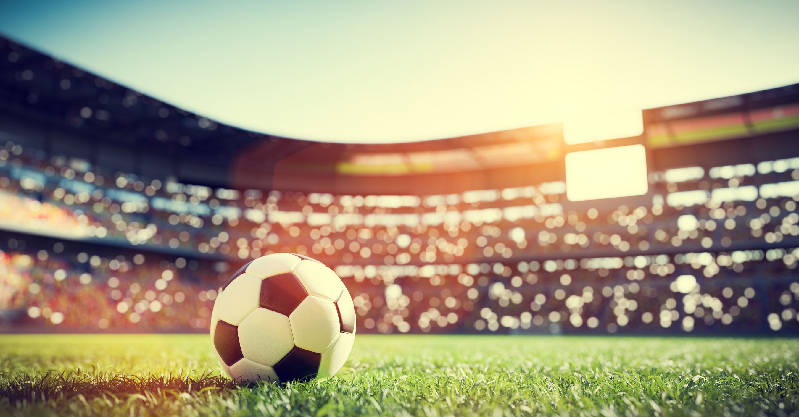 Football soccer ball on grass field on stadium